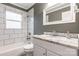 Bathroom features modern tile in the shower/tub and a vanity with granite countertop at 1400 Fern Forest Dr, Gastonia, NC 28054
