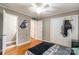 Bright bedroom features hardwood floors, ceiling fan, ample storage space in closets, and decor at 1400 Fern Forest Dr, Gastonia, NC 28054