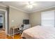 Neutral bedroom features a desk and good light from the window; ceiling fan for comfort at 1400 Fern Forest Dr, Gastonia, NC 28054