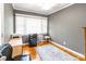 Bedroom features a large window for good natural light, ceiling fan, and hardwood floors at 1400 Fern Forest Dr, Gastonia, NC 28054