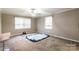Bedroom with neutral paint, carpet, ceiling fan and natural light streaming in through the window at 1400 Fern Forest Dr, Gastonia, NC 28054