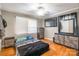 Comfortable bedroom features hardwood floors, neutral walls, modern ceiling fan, and dresser storage at 1400 Fern Forest Dr, Gastonia, NC 28054
