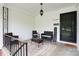 Welcoming front porch with cozy seating and charming decor elements at 1400 Fern Forest Dr, Gastonia, NC 28054