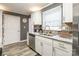 Updated kitchen features stainless steel appliances, white cabinets, granite countertops, and tiled backsplash at 1400 Fern Forest Dr, Gastonia, NC 28054
