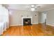 Inviting living room featuring hardwood floors, fireplace, and abundant natural light at 1400 Fern Forest Dr, Gastonia, NC 28054
