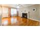 Inviting living room featuring hardwood floors, fireplace, and abundant natural light at 1400 Fern Forest Dr, Gastonia, NC 28054
