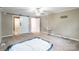 Spacious main bedroom features a large closet, a ceiling fan, neutral paint, and a cozy chair at 1400 Fern Forest Dr, Gastonia, NC 28054