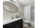 Bathroom featuring a white vanity, dark cabinets, and an oval mirror at 141 Hickory Creek Dr, Gastonia, NC 28052
