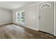 The entry way features laminate floors, a modern door, and three windows with backyard views at 141 Hickory Creek Dr, Gastonia, NC 28052