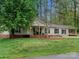 Charming single-story home with a brick foundation, vinyl siding, covered front porch, and carport at 141 Hickory Creek Dr, Gastonia, NC 28052