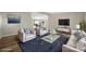 The living room features neutral paint, laminate floors, and comfortable seating with backyard views at 141 Hickory Creek Dr, Gastonia, NC 28052
