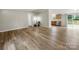 Living room featuring modern laminate floors that lead into the kitchen and patio area at 141 Hickory Creek Dr, Gastonia, NC 28052