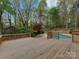 Inviting backyard features a spacious wooden deck and sparkling in-ground pool, perfect for outdoor entertaining at 1437 Jules Ct, Charlotte, NC 28226