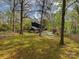 Expansive backyard showcasing a well-maintained lawn, mature trees, and a refreshing in-ground pool area at 1437 Jules Ct, Charlotte, NC 28226