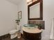 Stylish powder room featuring a vessel sink, decorative mirror, and modern fixtures at 1437 Jules Ct, Charlotte, NC 28226