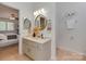 Well-lit bathroom with a round mirror, vanity, and access to the bedroom at 1437 Jules Ct, Charlotte, NC 28226