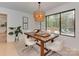Dining room with wooden table, stylish pendant lighting, and view of the deck at 1437 Jules Ct, Charlotte, NC 28226