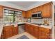 Kitchen with oak cabinets, stainless steel appliances, and a backyard view at 1437 Jules Ct, Charlotte, NC 28226