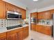 Well-equipped kitchen with wood cabinets, modern appliances, and tiled backsplash at 1437 Jules Ct, Charlotte, NC 28226