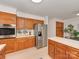 Kitchen with stainless steel refrigerator and oven with oak cabinets at 1437 Jules Ct, Charlotte, NC 28226
