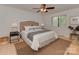 Cozy main bedroom featuring a ceiling fan and large window with natural light at 1437 Jules Ct, Charlotte, NC 28226