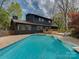 Backyard pool area featuring a blue inground pool, deck, and lounge chairs at 1437 Jules Ct, Charlotte, NC 28226