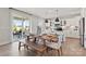 Dining area with a wooden table, bench seating, and open to a modern, bright kitchen at 1471 Hubert Graham Way, Tega Cay, SC 29708