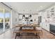 Bright dining area with a rustic wooden table, bench seating, and a view of the kitchen at 1471 Hubert Graham Way, Tega Cay, SC 29708