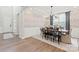 Formal dining room featuring stylish wallpaper accent, chandelier, and dining table with seating for six at 1471 Hubert Graham Way, Tega Cay, SC 29708