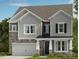Charming two-story home with a mix of stone and gray siding, and a covered front porch at 1471 Hubert Graham Way, Tega Cay, SC 29708