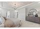 Primary bedroom with decorative ceiling, chandelier, bedside tables, and large windows at 1471 Hubert Graham Way, Tega Cay, SC 29708