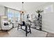 Bright office featuring large windows, a modern desk, stylish shelving, and a comfortable armchair at 1471 Hubert Graham Way, Tega Cay, SC 29708