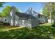 Lush backyard showcasing the back of the home with mature trees and landscaping at 1532 Hunt Club Ct, Rock Hill, SC 29732