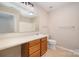 Well-lit bathroom with a single sink, wooden cabinets, and neutral walls at 1532 Hunt Club Ct, Rock Hill, SC 29732