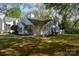 Charming home exterior featuring manicured lawn and mature trees providing ample shade at 1532 Hunt Club Ct, Rock Hill, SC 29732
