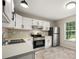 Bright kitchen featuring white cabinets, stainless steel appliances, and natural light at 1532 Hunt Club Ct, Rock Hill, SC 29732
