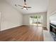 Open living room featuring hardwood floors, a fireplace, and sliding glass doors for natural light at 1532 Hunt Club Ct, Rock Hill, SC 29732