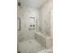 Modern tiled walk-in shower features a built-in seat, grab bar, and rainfall shower head at 1532 Hunt Club Ct, Rock Hill, SC 29732