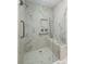 Modern tiled walk-in shower features a built-in seat, grab bar, and rainfall shower head at 1532 Hunt Club Ct, Rock Hill, SC 29732