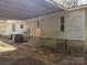 Backyard view of home, showing siding, covered area, and air conditioning unit at 1586 Brook Ln, Denver, NC 28037