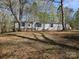 Exterior view of house with blue shutters, set on a spacious, tree-filled lot at 1586 Brook Ln, Denver, NC 28037