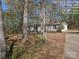 Exterior of property with mature trees and partial driveway in view at 1586 Brook Ln, Denver, NC 28037