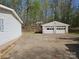 Detached two-car garage with concrete driveway and mature trees at 1586 Brook Ln, Denver, NC 28037