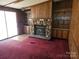 Cozy living room with stone fireplace, built-in shelving, and sliding door at 1586 Brook Ln, Denver, NC 28037
