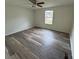 Bright bedroom with ceiling fan and large window bringing in natural light at 1628 B Se Ave, Hickory, NC 28602