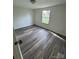 Cozy bedroom featuring durable laminate flooring and a sunlit window view at 1628 B Se Ave, Hickory, NC 28602