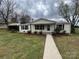 Inviting single-story house with a carport, manicured bushes, and a cozy front porch at 1628 B Se Ave, Hickory, NC 28602