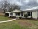 Charming single-story home featuring a welcoming front porch and mature landscaping at 1628 B Se Ave, Hickory, NC 28602