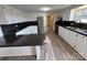 Modern kitchen featuring white cabinets, dark countertops, stainless steel appliances, and wood floors at 1628 B Se Ave, Hickory, NC 28602