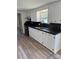 Galley kitchen featuring white cabinets, modern countertops, and sleek stainless steel appliances at 1628 B Se Ave, Hickory, NC 28602